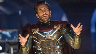 Jake Gyllenhaal gestures widely with his hands while wearing his Mysterio suit in Spider-Man: Far From Home.