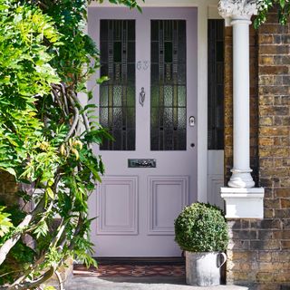 lilac front door with stained glass windows, planter, Victorian style home