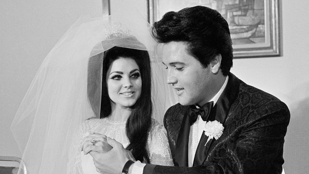 Elvis Presley shows off his wife Princilla&#039;s three-carat diamond wedding ring on their wedding day in Las Vegas.