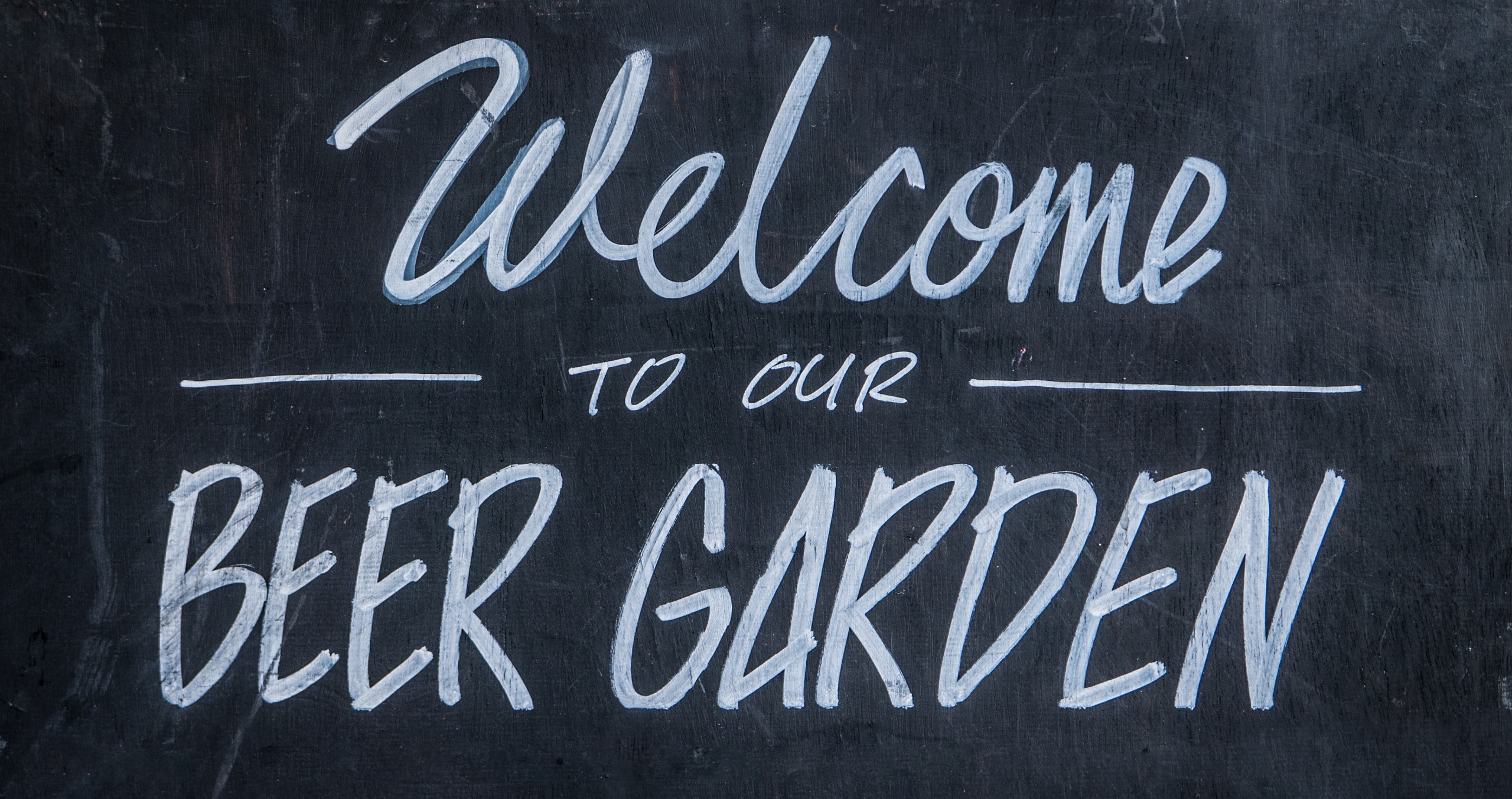 Chalkboard that says "Welcome to our Beer Garden"