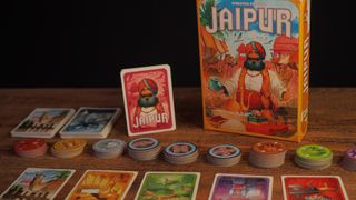 Jaipur box, cards, and tokens laid out on a wooden table