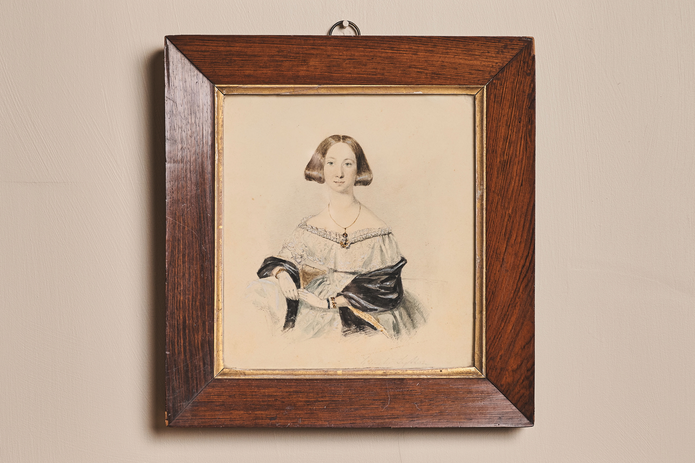 The framed portrait, facing front on. A fine pencil drawing of a young woman in the mid-19th-century.