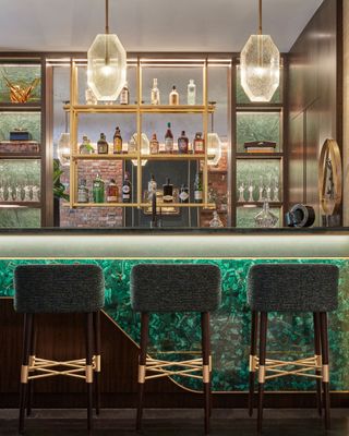 Green textured bar, dark wood and gold shelves