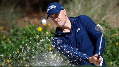 Jordan Spieth plays a shot from a bunker on the 14th hole on the Stadium Course at TPC Sawgrass