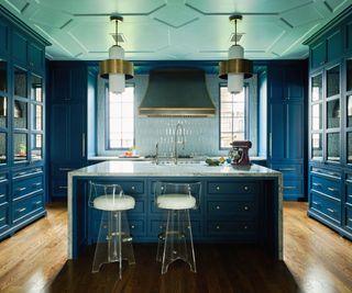 dark blue kitchen with lacquered cabinets and island with ceiling detail