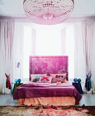 pink bed in front of the window