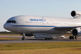 The Orbital ATK L-1011 Stargazer carrier plane arrives at its Cape Canaveral Air Force Station runway in Florida on Dec. 2, 2016 ahead of its Dec. 12 launch of the Pegasus XL rocket (attached to the plane) carrying NASA's eight Cyclone Global Navigation Satellite System.