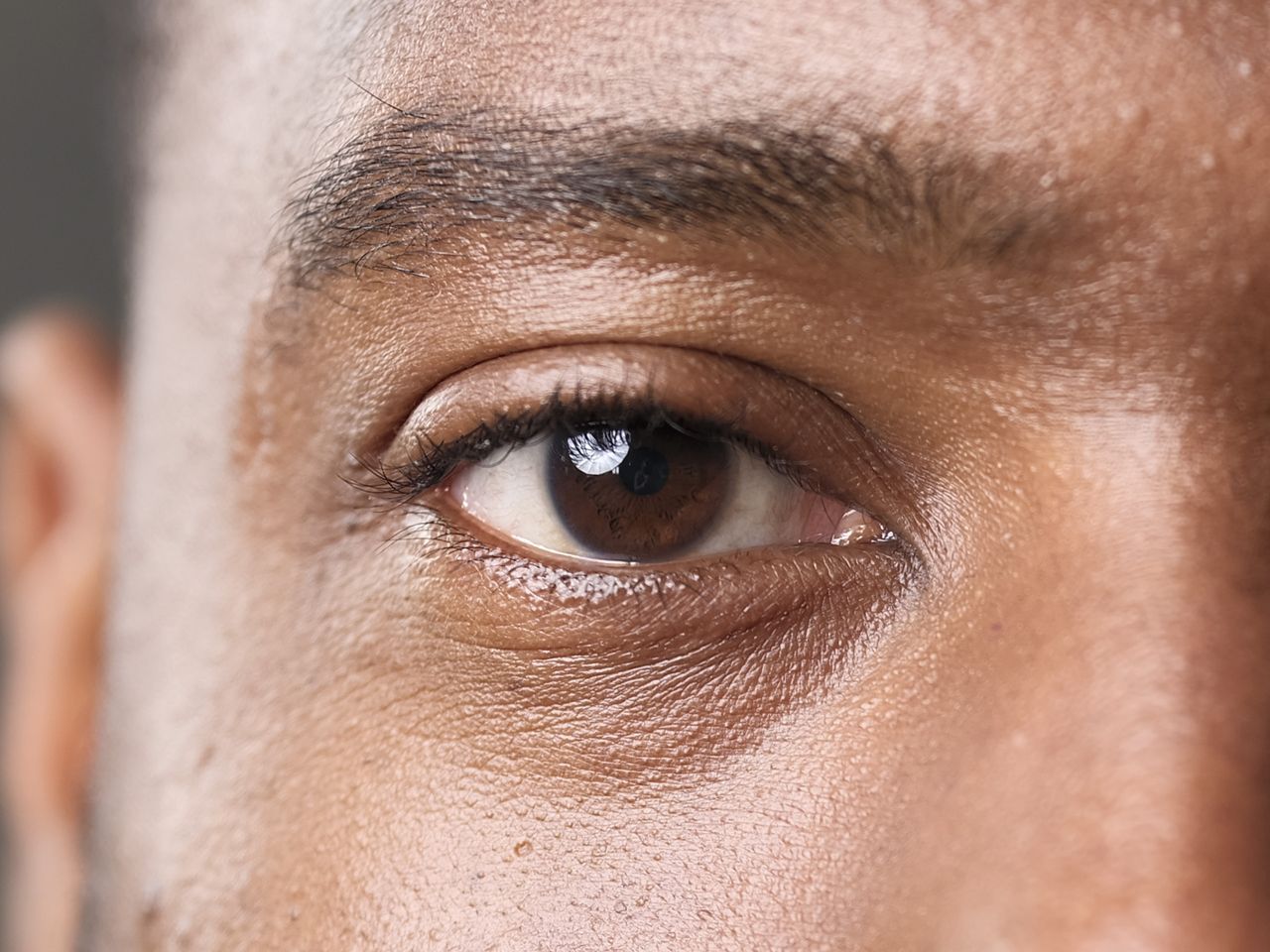 Studio portrait closeup of model's eye and the focus is on the iris