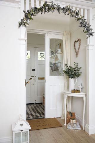 hallway with white flower vase and doormat