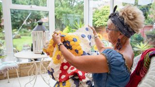 A lady admires her quilted blanket