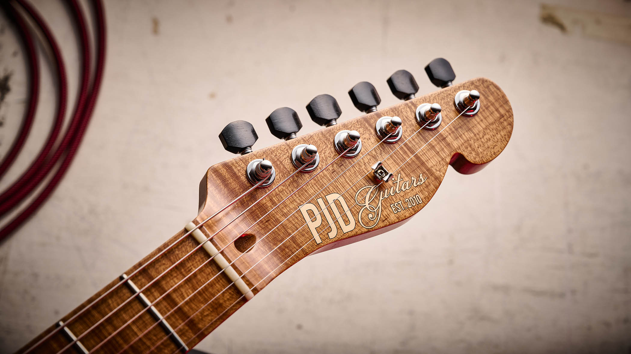 PJD Carey Classic: the translucent white singlecut has a handsome roasted figured maple neck, a black pickguard, and a P-90/Humbucker pairing.