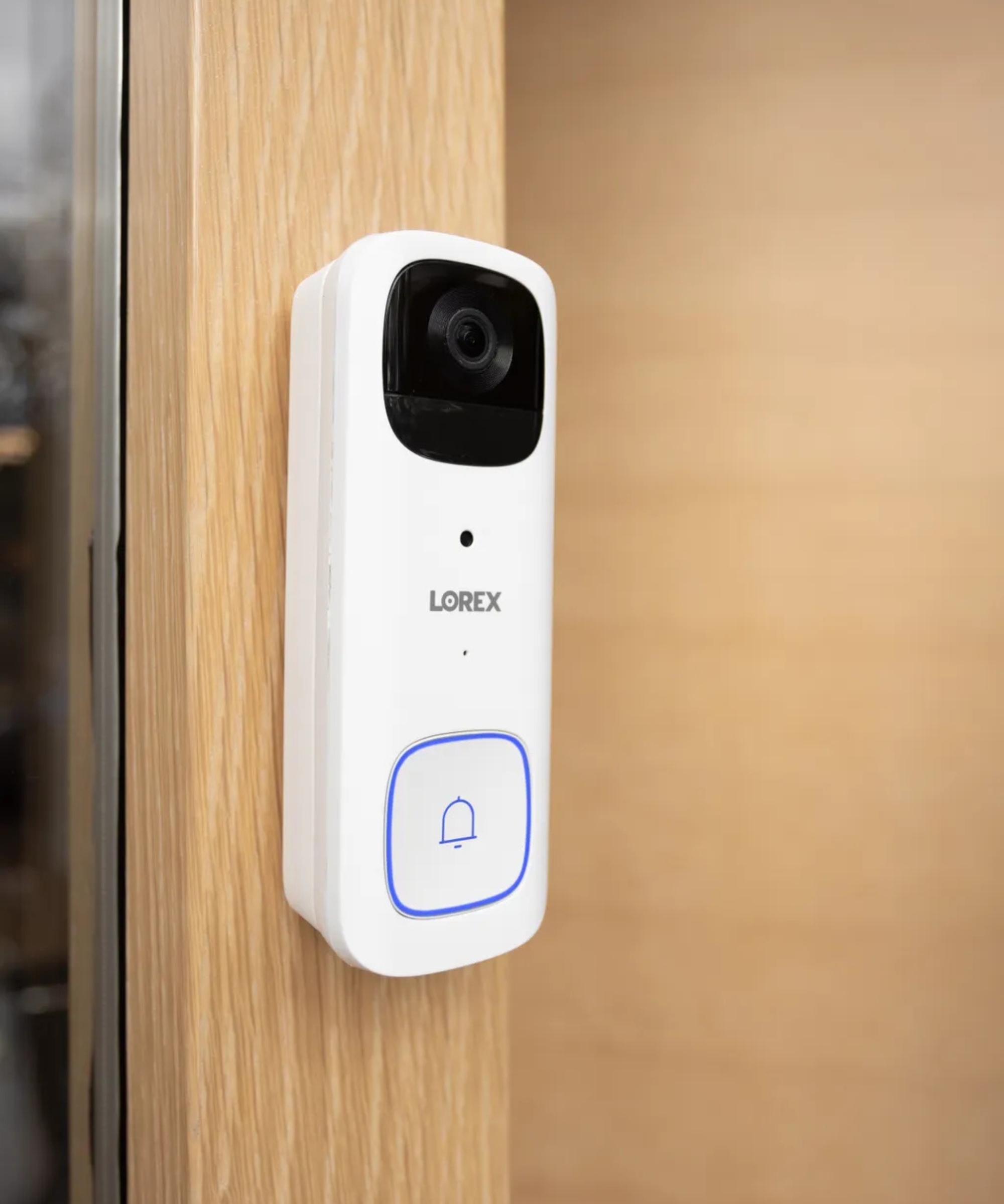 Lorex 2K Wi-Fi Video Doorbell mounted on wooden doorframe.
