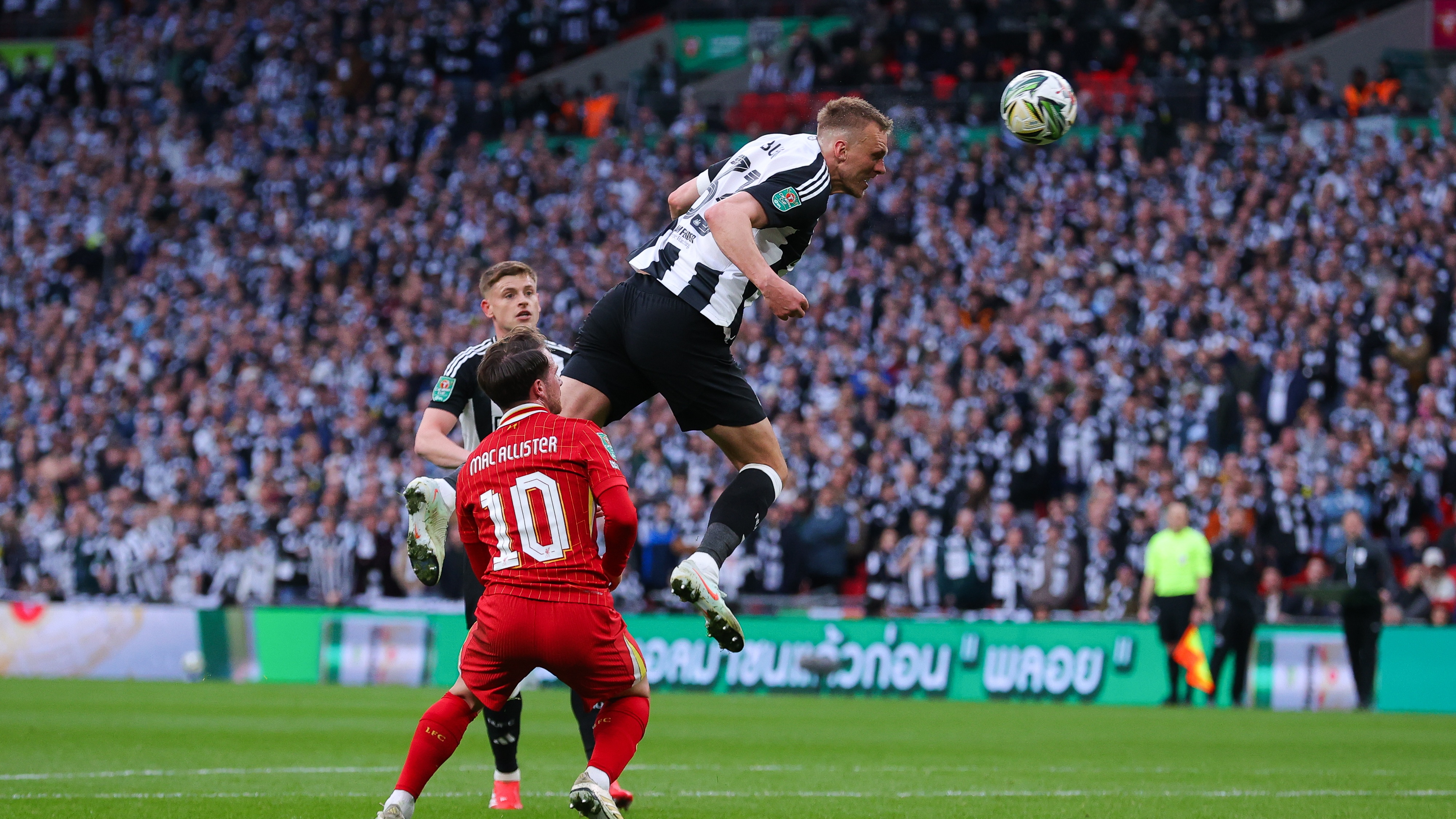 Dan Burn of Newcastle United scores their side's first goal during the Carabao Cup Final between Liverpool and Newcastle United at Wembley Stadium on March 16, 2025 in London, England.
