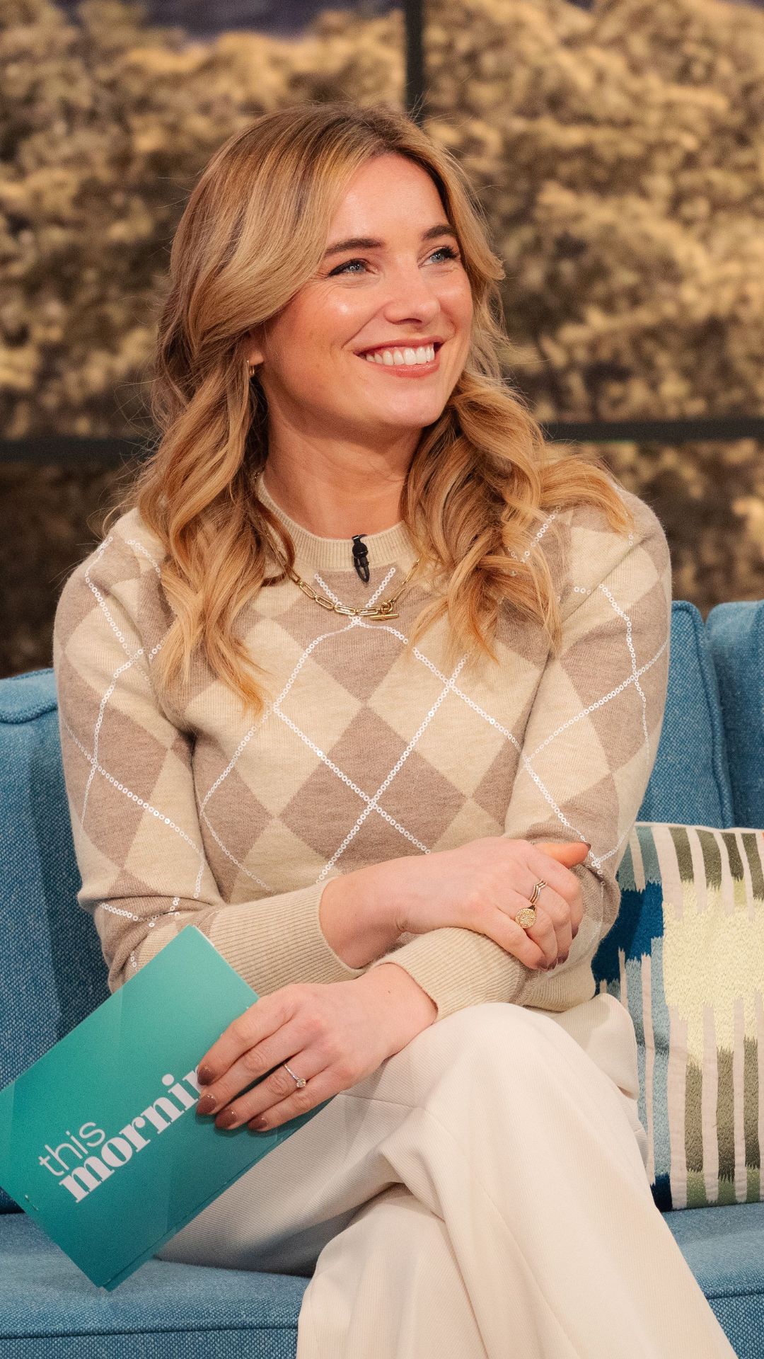 SIAN WELBY WEARING AN ARGYLE JUMPER