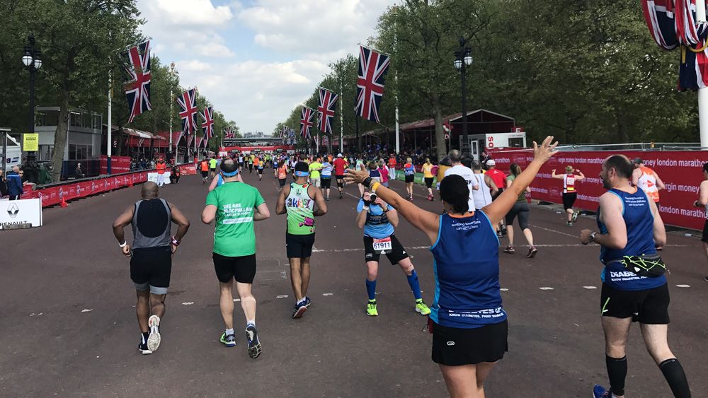 Runners in the London Marathon approach the finish line on the Mall