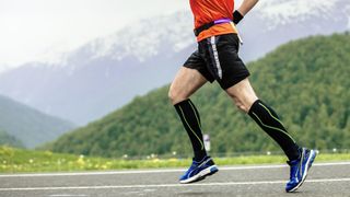 Runner wearing compression socks on road