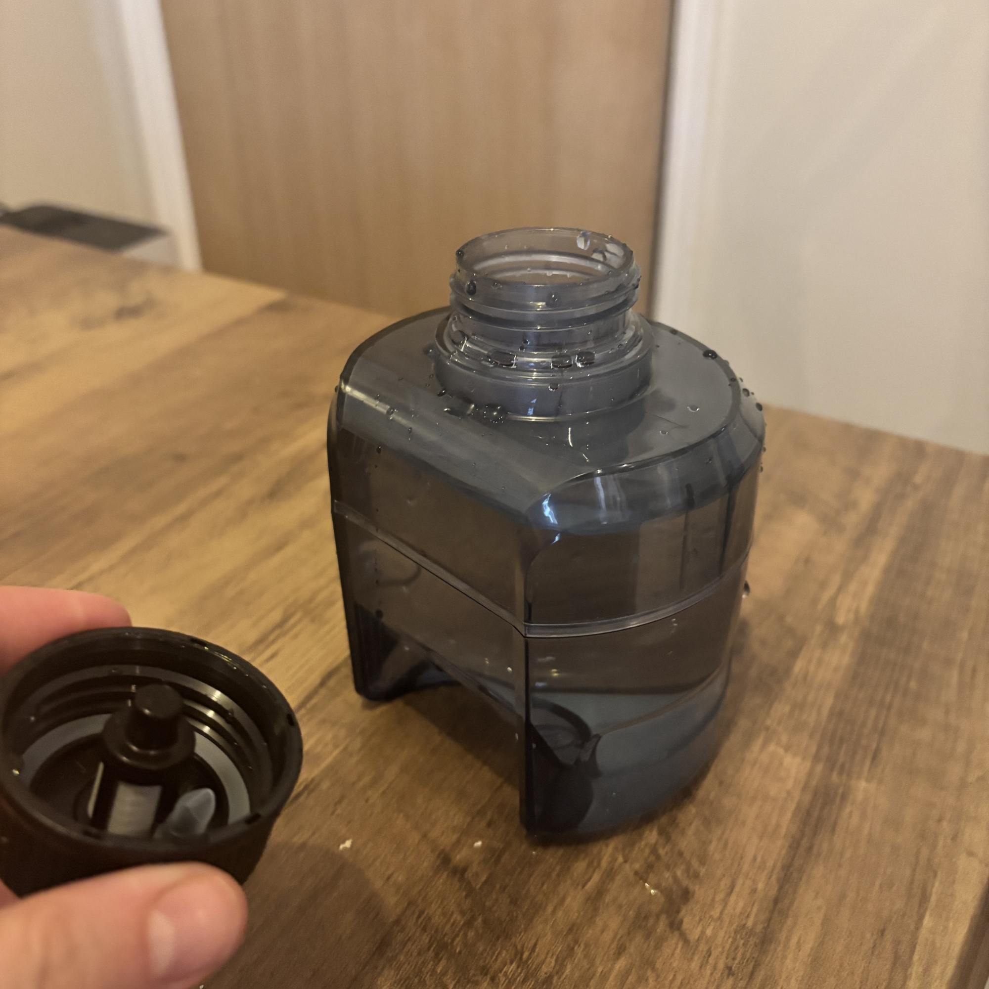 Beldray hard floor cleaner water tank removed from unit, on wooden table with lid removed