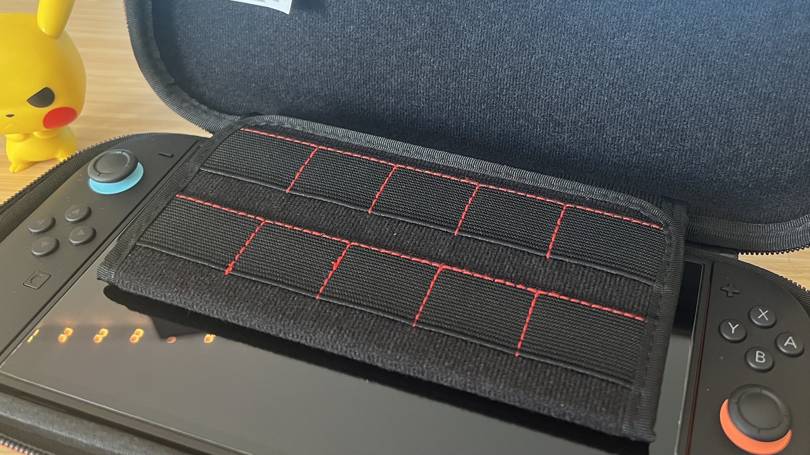 PowerA Slim Case for Nintendo Switch 2 open with game cart sleeve visible on top of the console