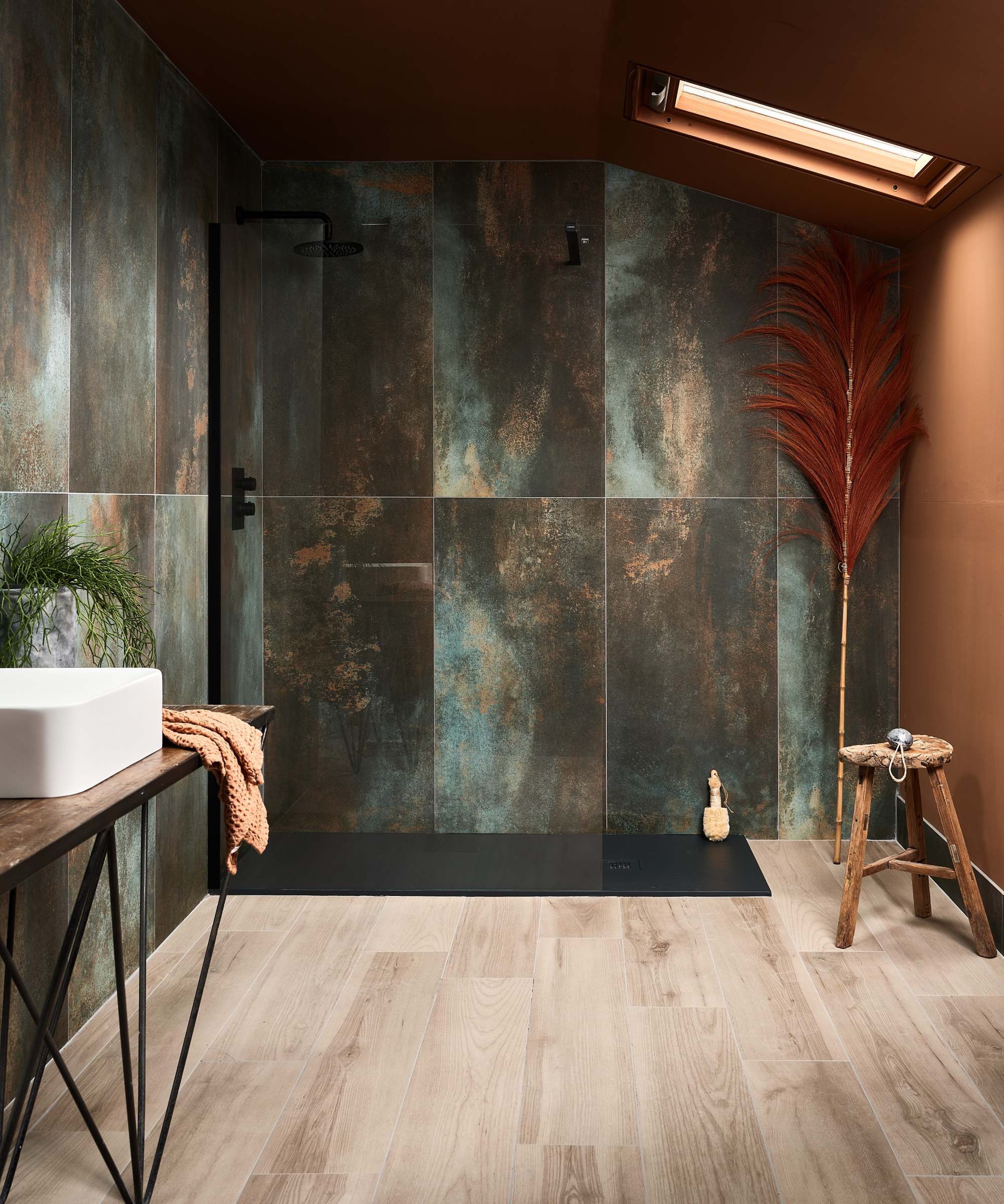 walk in shower with tiled walls, black shower tray, rooflight and wood effect floor tiles