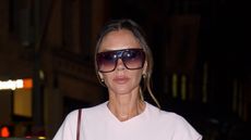 Victoria Beckham in a pastel pink dress and big sunglasses