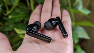 UGREEN HiTune T3 ANC earbuds held in the palm of a hand