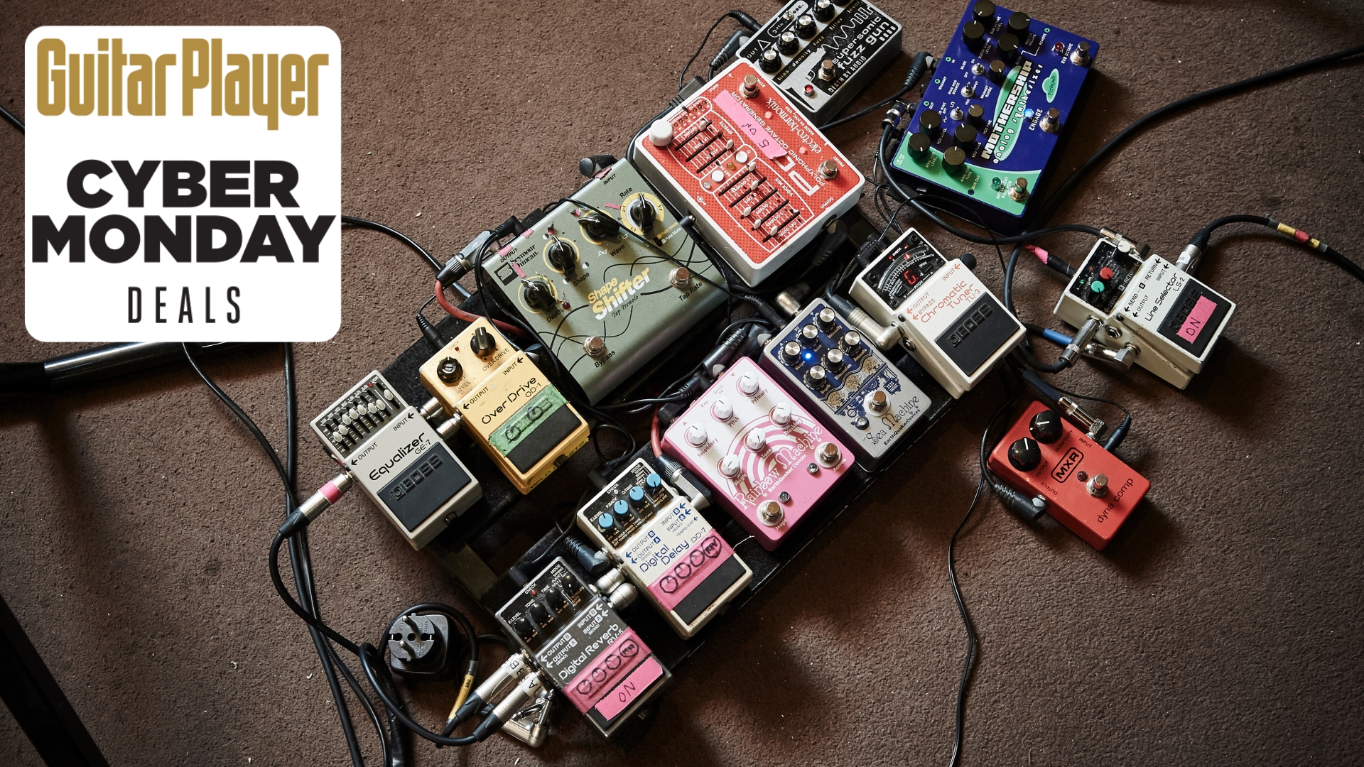 A pedalboard lying on the floor of a rehearsal room