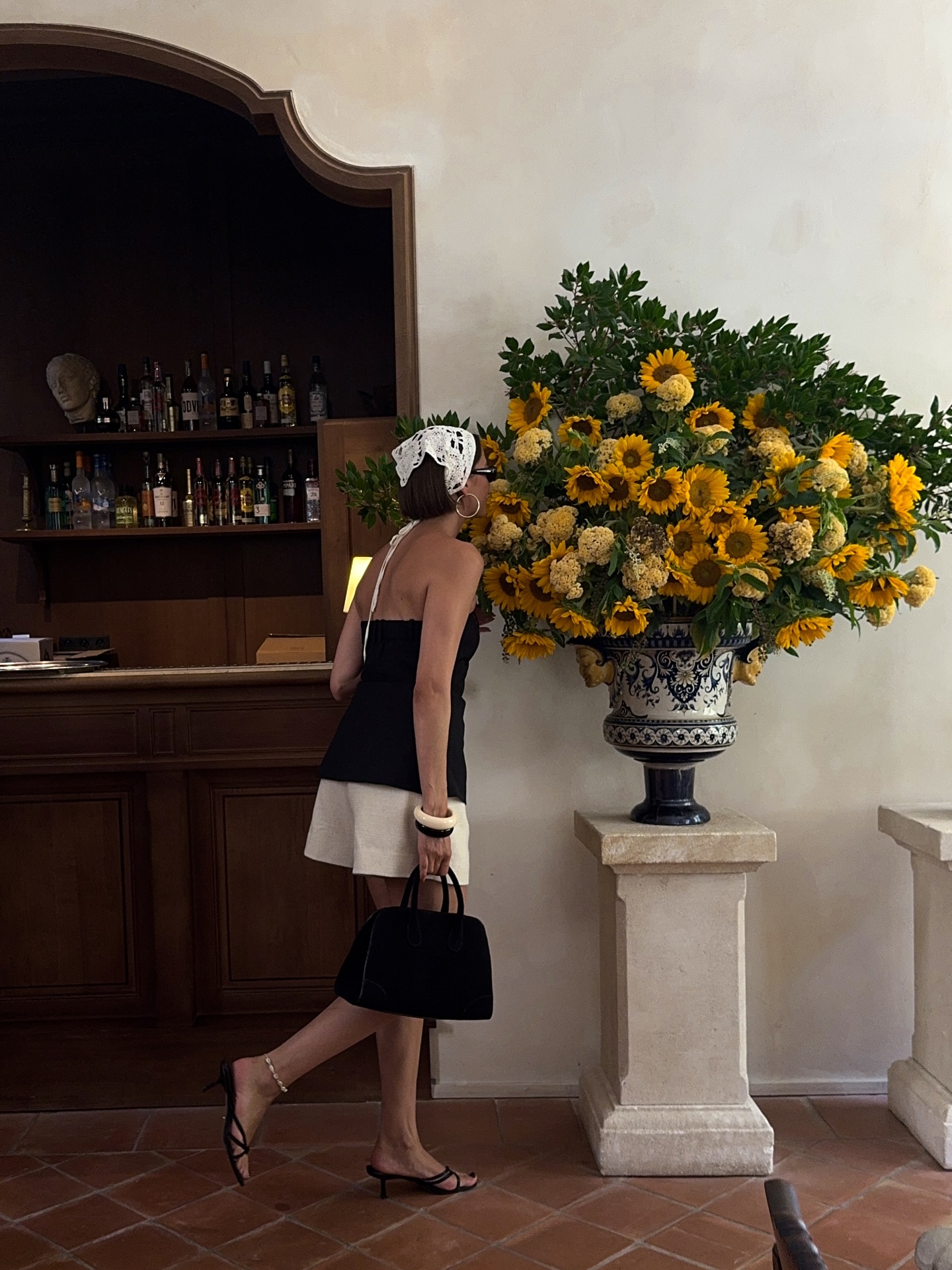 Mary L. Jean smells a sunflower bouquet while visiting Nice