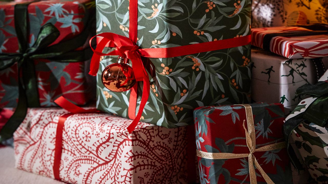 Christmas presents with gift wrap and red ribbon