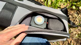 Nomatic LUMA Camera Pack open on the ground outdoors and showing the contents of the backpack