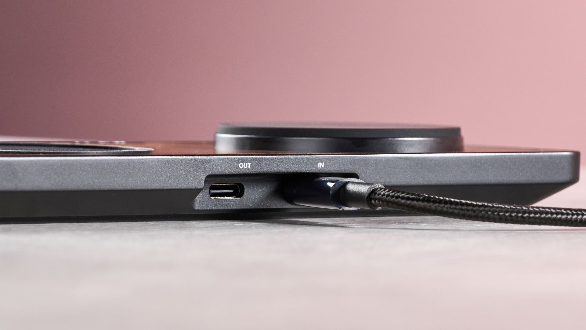 Rear view of the charger showing the USB-C in and out ports. A braided USB-C cable is connected to the power-in port.