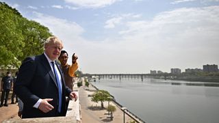 Boris Johnson looks over the Sabarmati river during his visit at the Sabarmati Ashram