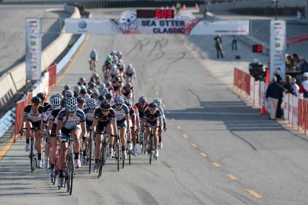 The women's field rolls through the start/finish area on their second lap.