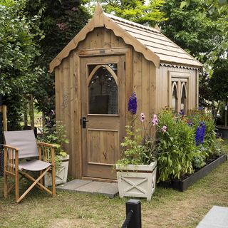 wooden shed with flower bed borders