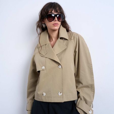 Model wears H&M v-neck white jumper.