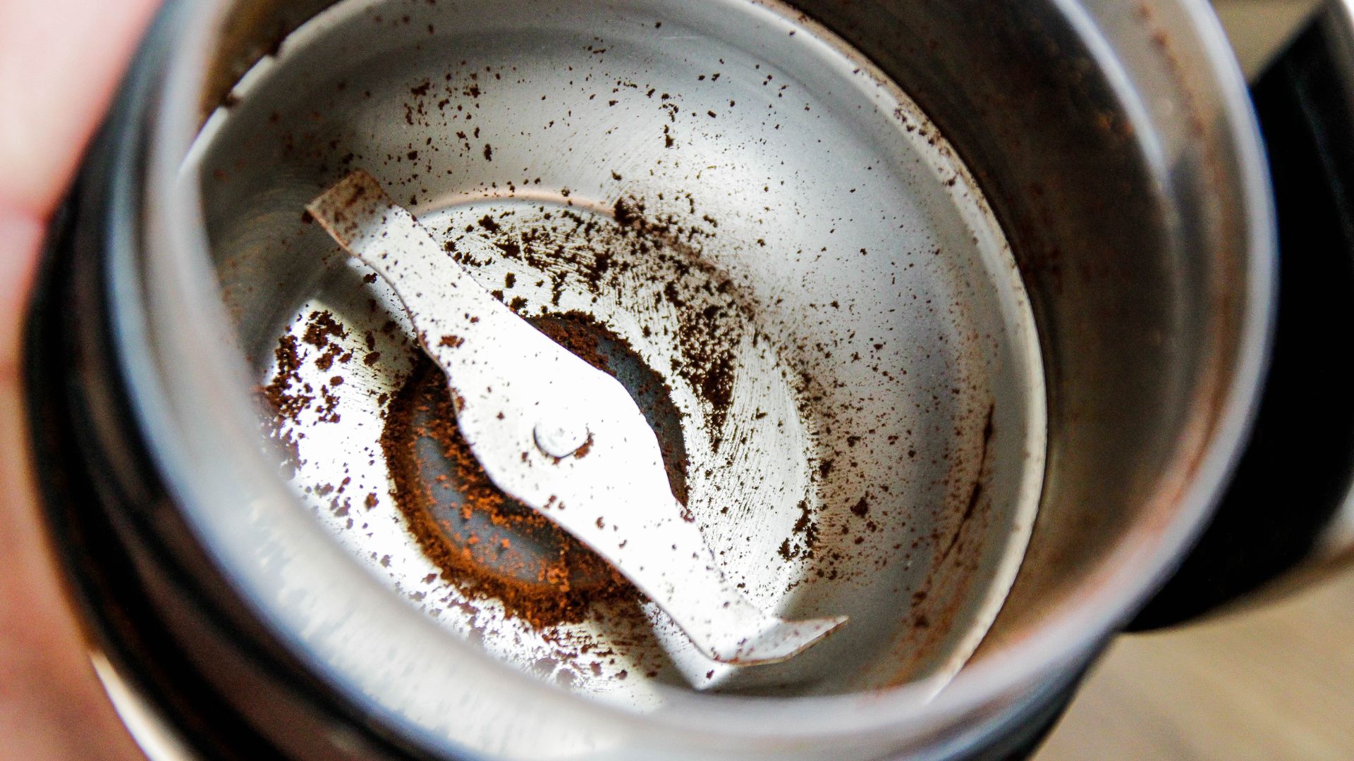 empty coffee grinder with left over grounds inside