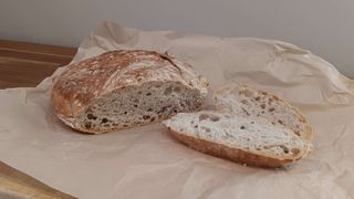 No-knead bread on baking parchment, sliced