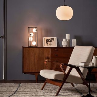 Grey living room with mid-century furniture and glass pendant light