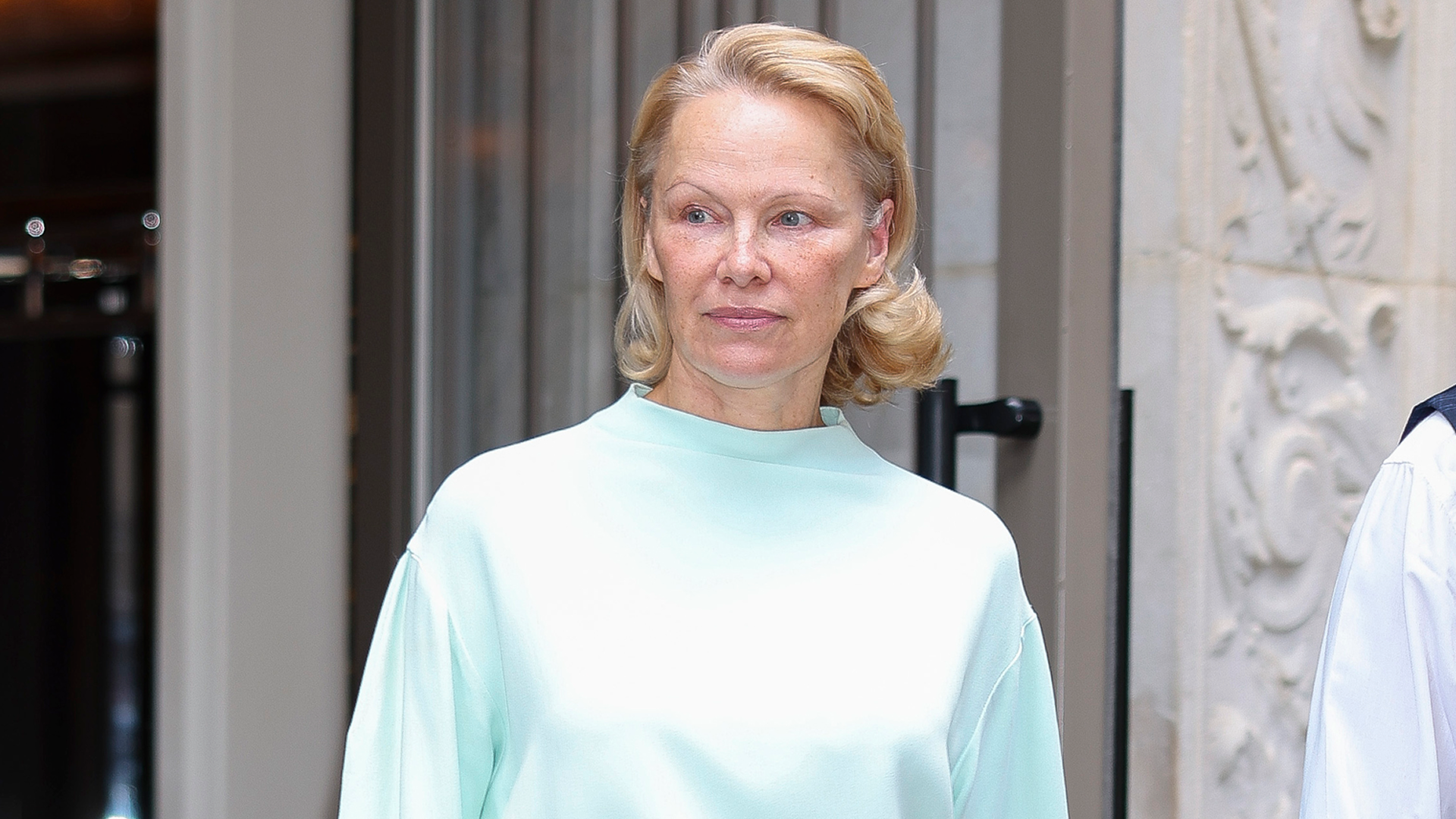 Pamela Anderson paired a monochromatic skirt set with Strathberry&#039;s Mosaic Bag.