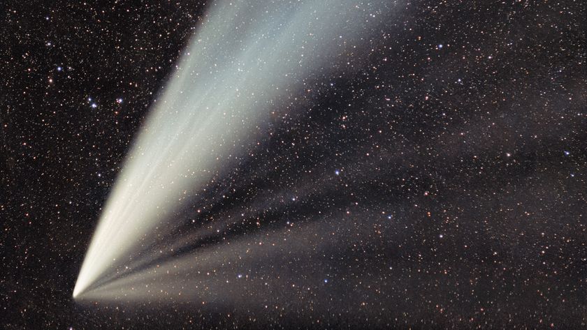 A photo of a large, white comet tail in space