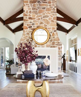 Grand entrance, vaulted ceiling, wooden beams, large fireplace and chimney breast, round table