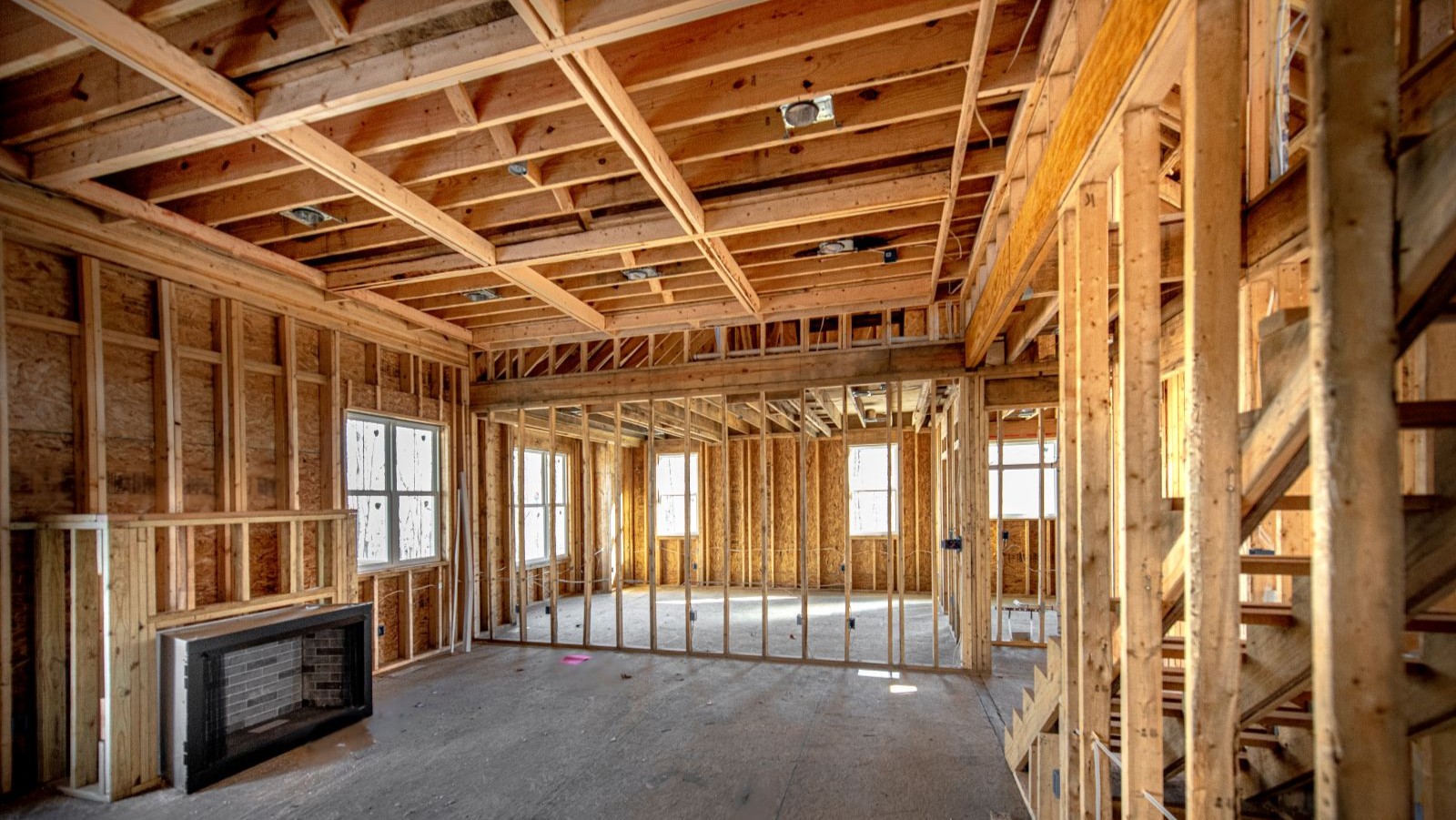 The interior of a build with timber exposed and a screed floor