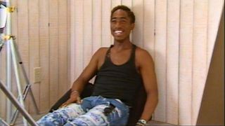 A young Tupac Shakur in a black tank in Dear Mama