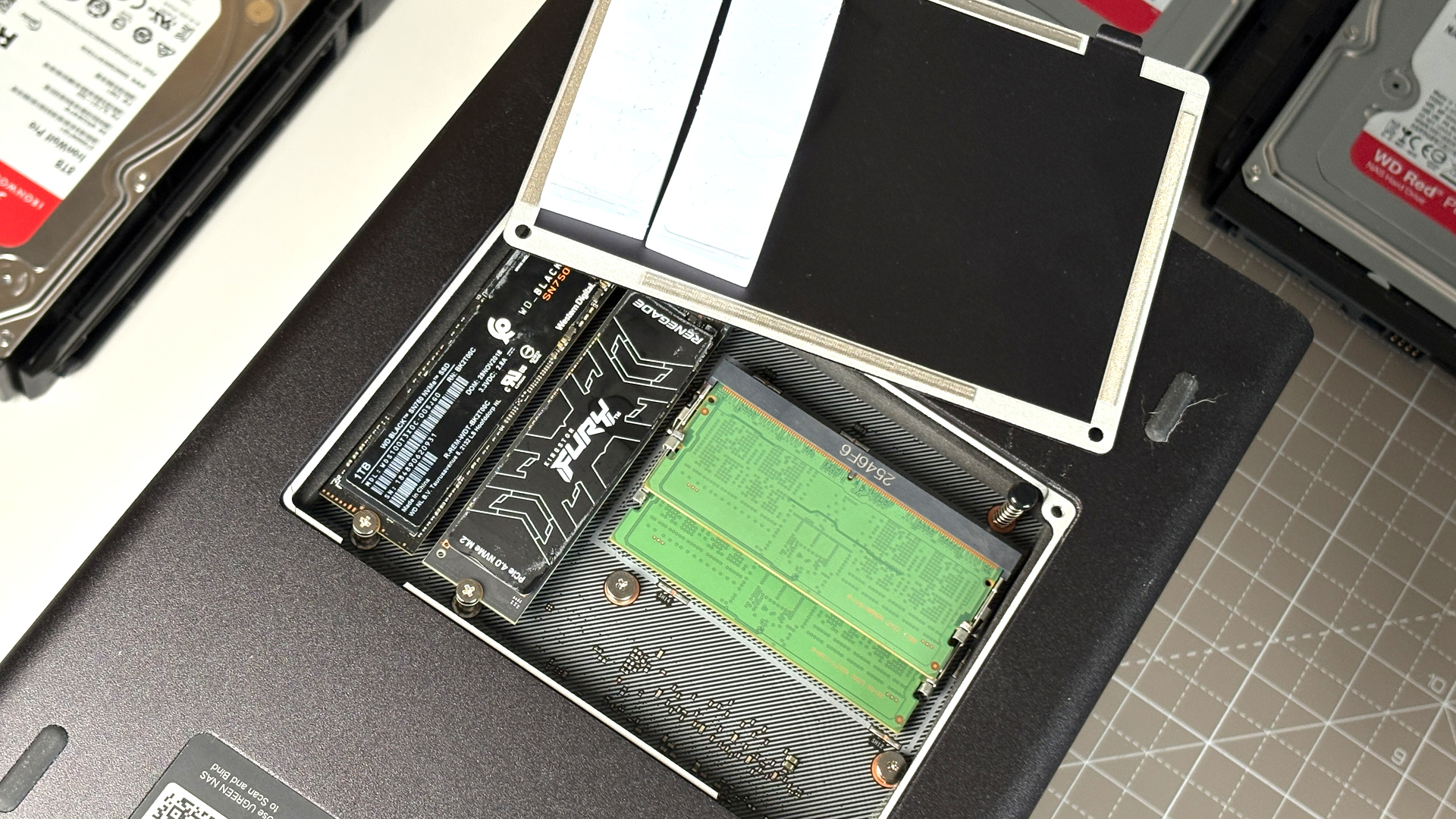 UGreen NASync DXP4800 Pro on a desk with multiple HDDs installed.
