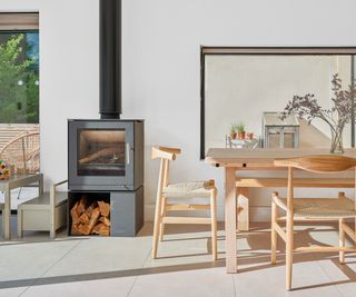 Contemporary wooden scandi style dining table with black woodburning stove