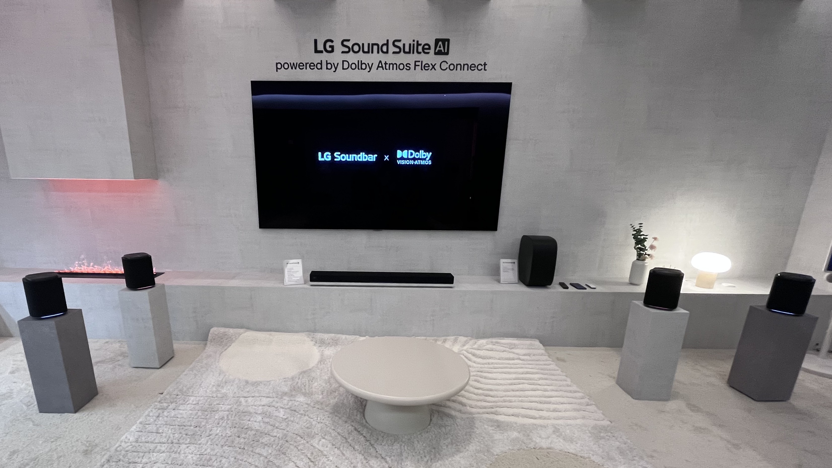 LG Sound Suite H7 soundbar in white room with LG TV and wireless speakers