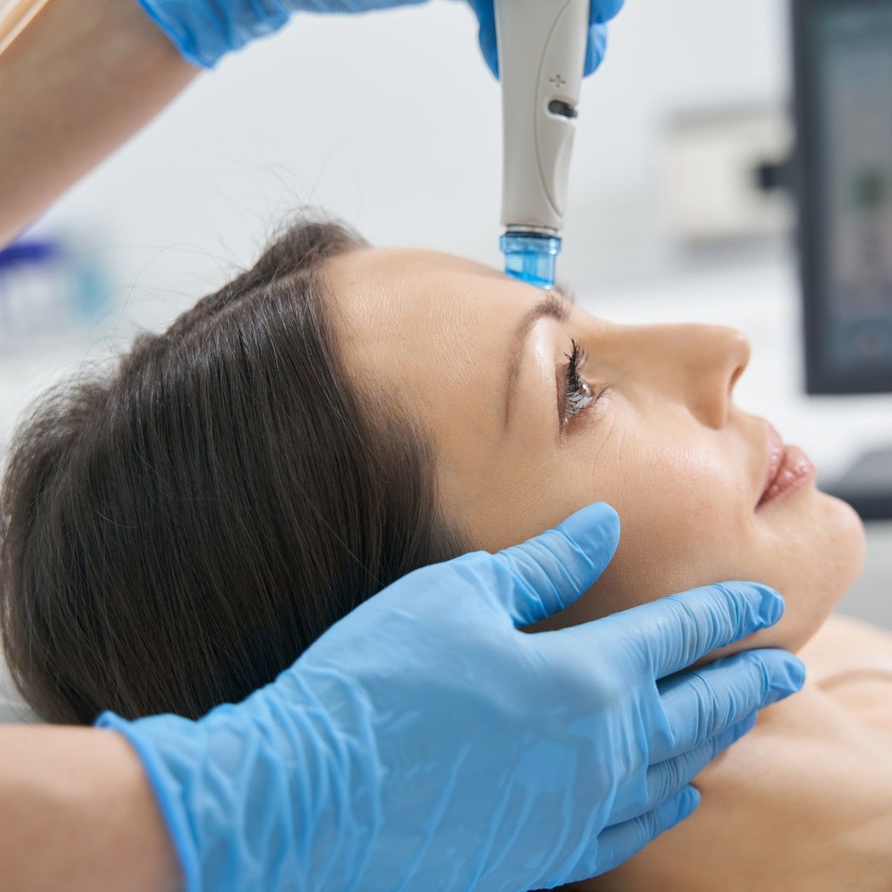 woman getting a hydrafacial in a spa