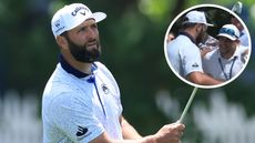 Jon Rahm hits an iron shot and hugs a spectator