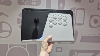 Man holding up FlexStrike Wireless Fight Stick against wall