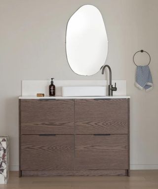 IKEA bathroom which has been updated using replacement door fronts in a dark oak material