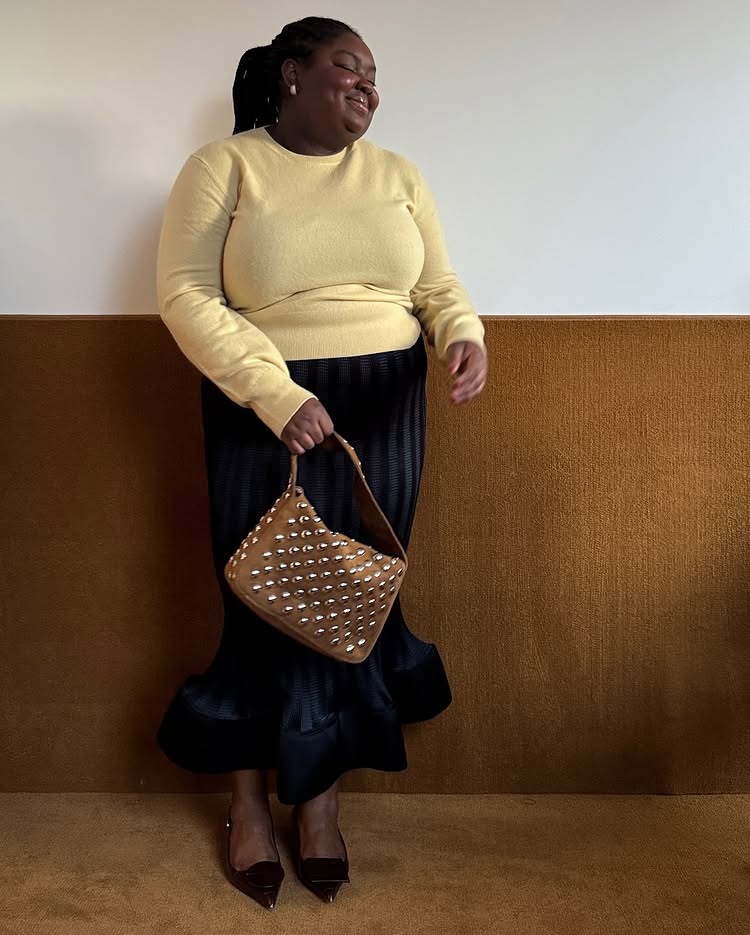 An image of @abimarvel wearing a butter yellow long-sleeve, pencil skirt and pointed-toe slingbacks.